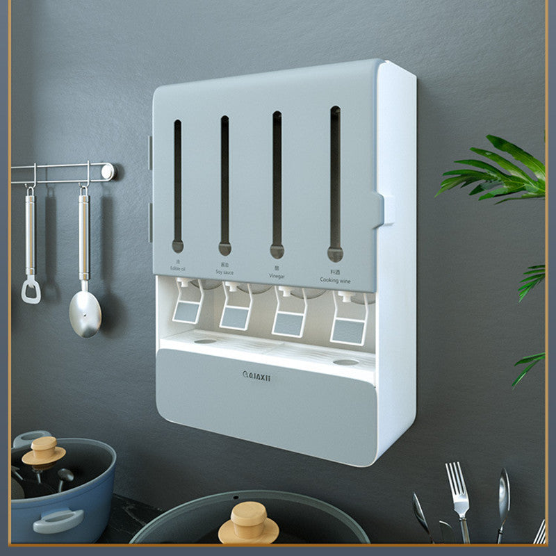 Wall-mounted kitchen utensil holder with various utensils on a gray wall.