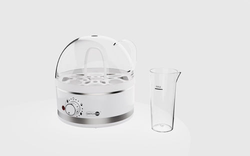 Clear glass beaker and white electronic device on a light gray background
