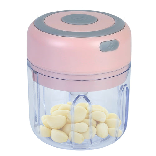 Pink handheld chopper with garlic cloves inside on a white background