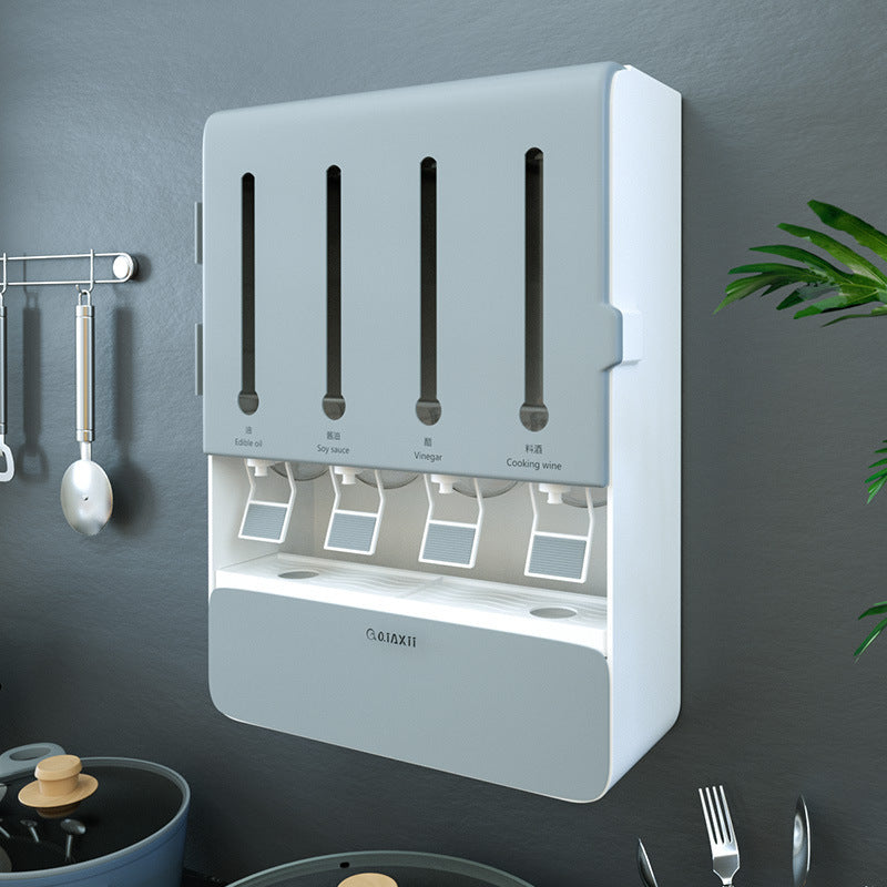 Wall-mounted utensil holder with multiple compartments on a dark gray wall.